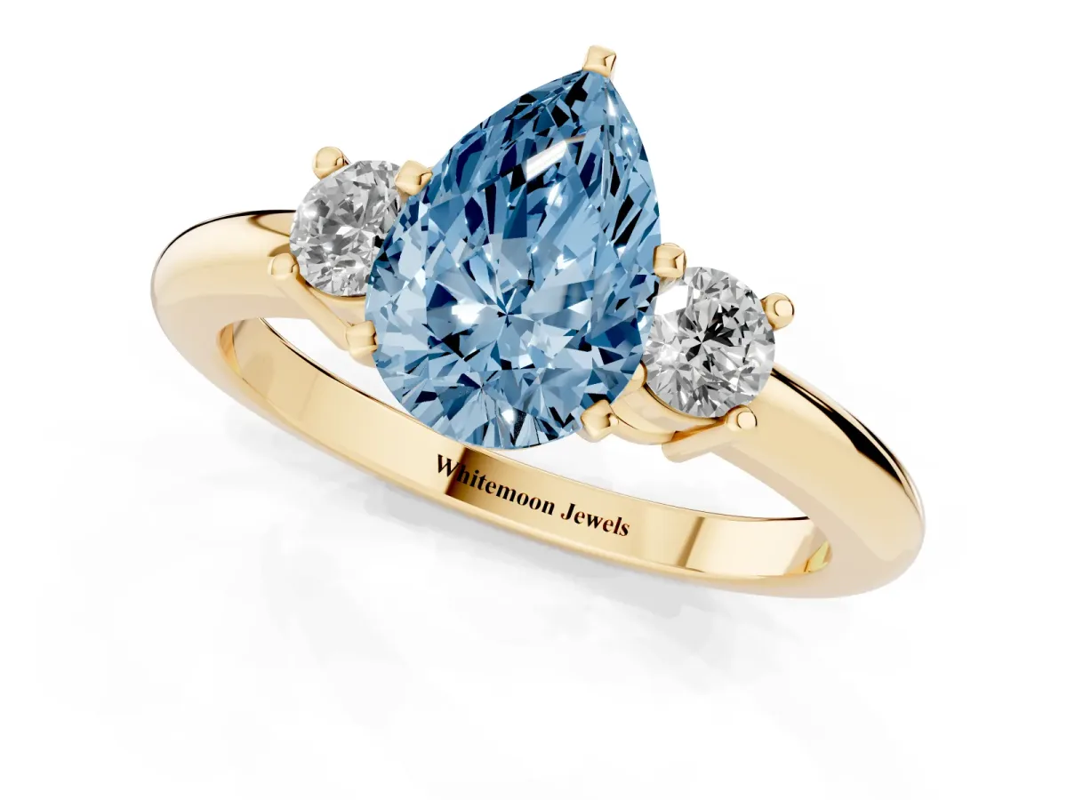 Fancy Blue Three-Stone Pear Cut Cut Diamond Solitaire with Prong Setting and Classic Band Yellow gold