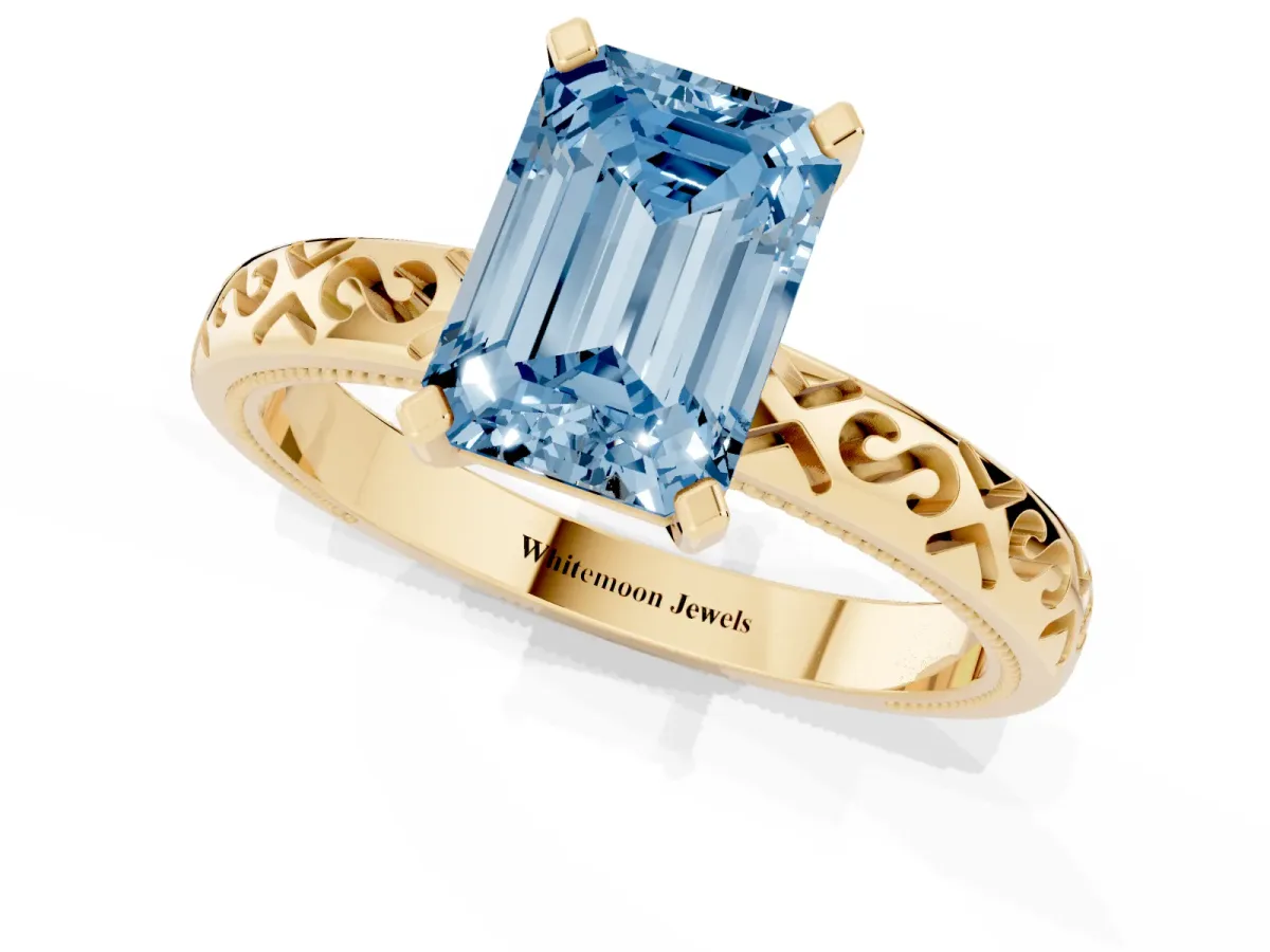 Fancy Blue Emerald Cut Solitaire Engagement Ring with Scrollwork Band and Four-Prong Setting Yellow gold