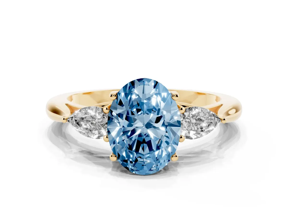 Fancy Blue Oval Cut Diamond Three-Stone Ring with Pear Side Stones and Prong Setting Yellow gold