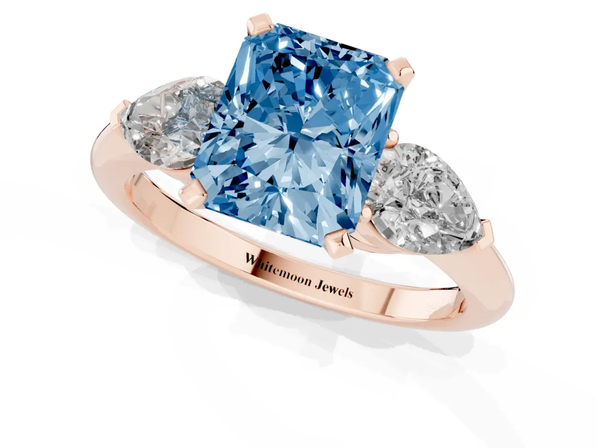 Fancy Blue Three-Stone Radiant Cut Diamond Ring with Pear Side Stones and Four-Prong Setting Rose gold