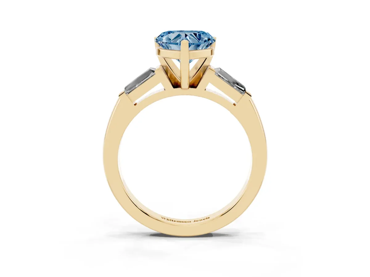 Fancy Blue Heart Cut Solitaire with Tapered Baguette Side Stones on a Classic Band with Four-Prong Setting Yellow gold