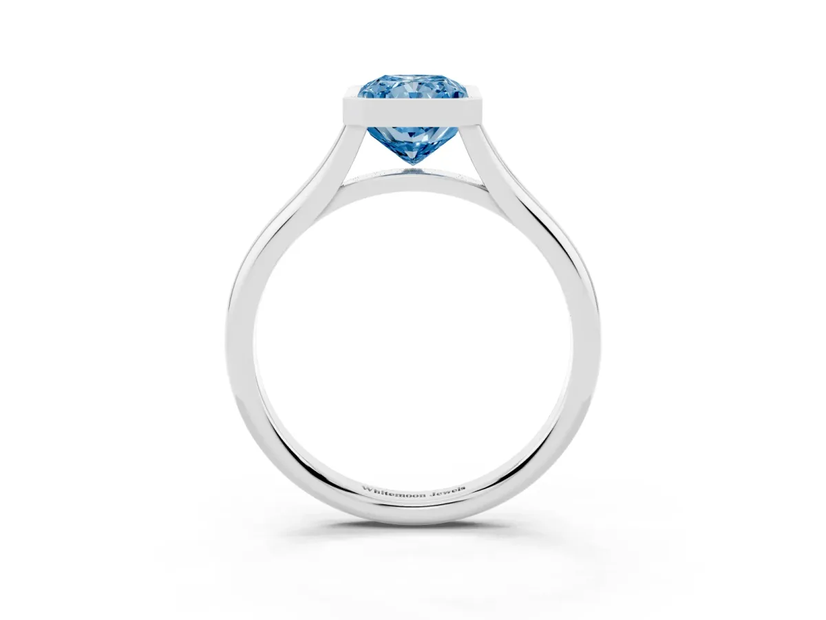 Fancy Blue Bezel Set Radiant Cut Cut Solitaire Ring with Tapered Band Silver