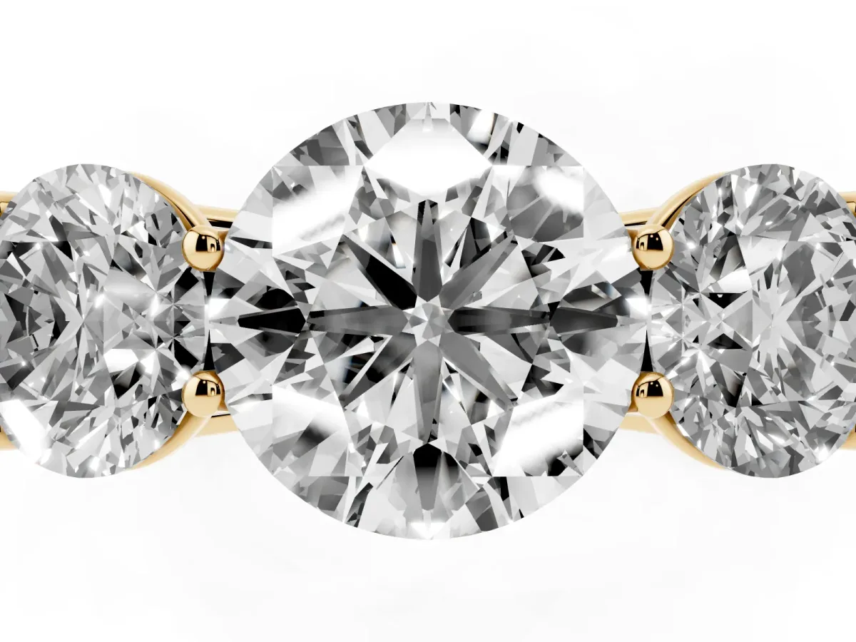 Round Cut Three-Stone Diamond Ring with Prong Setting on a Classic Band Yellow gold