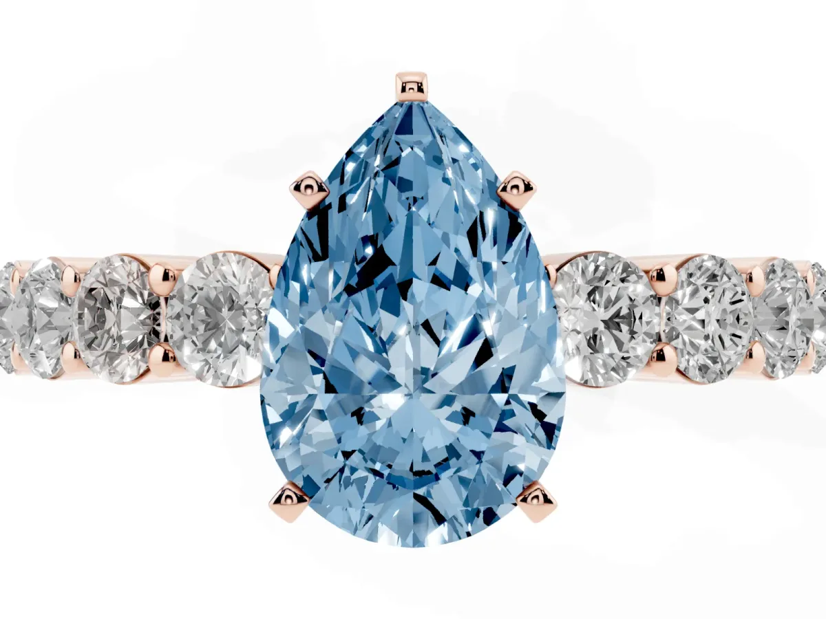 Fancy Blue Pear Cut Diamond Solitaire Ring with Shared Prong Round Side Stones Rose gold