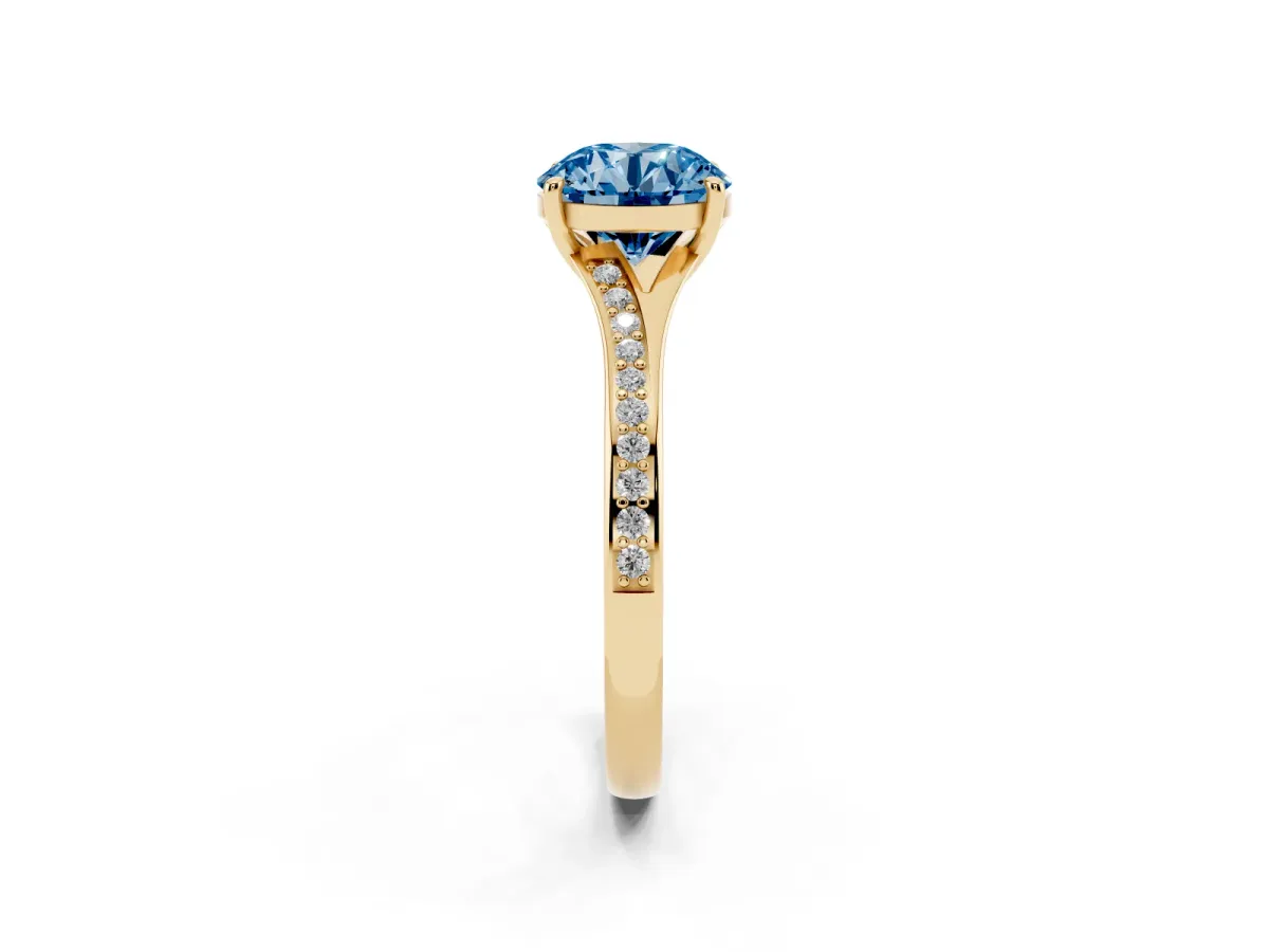 Fancy Blue Round Cut Diamond Solitaire Ring with Pavé Band and Prong Setting Yellow gold
