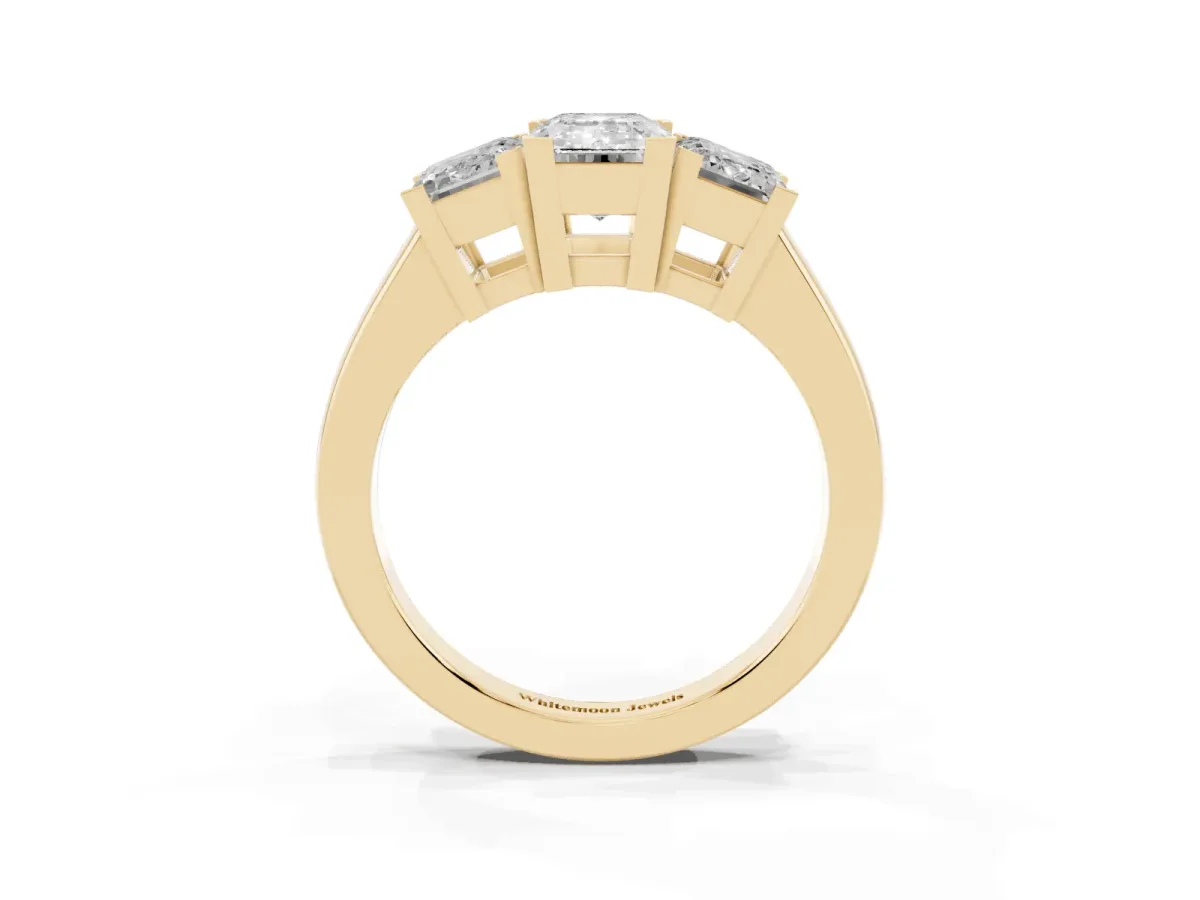 Three-Stone Emerald Cut Cut Diamond Ring with Channel Set Band and Four-Prong Setting Yellow gold
