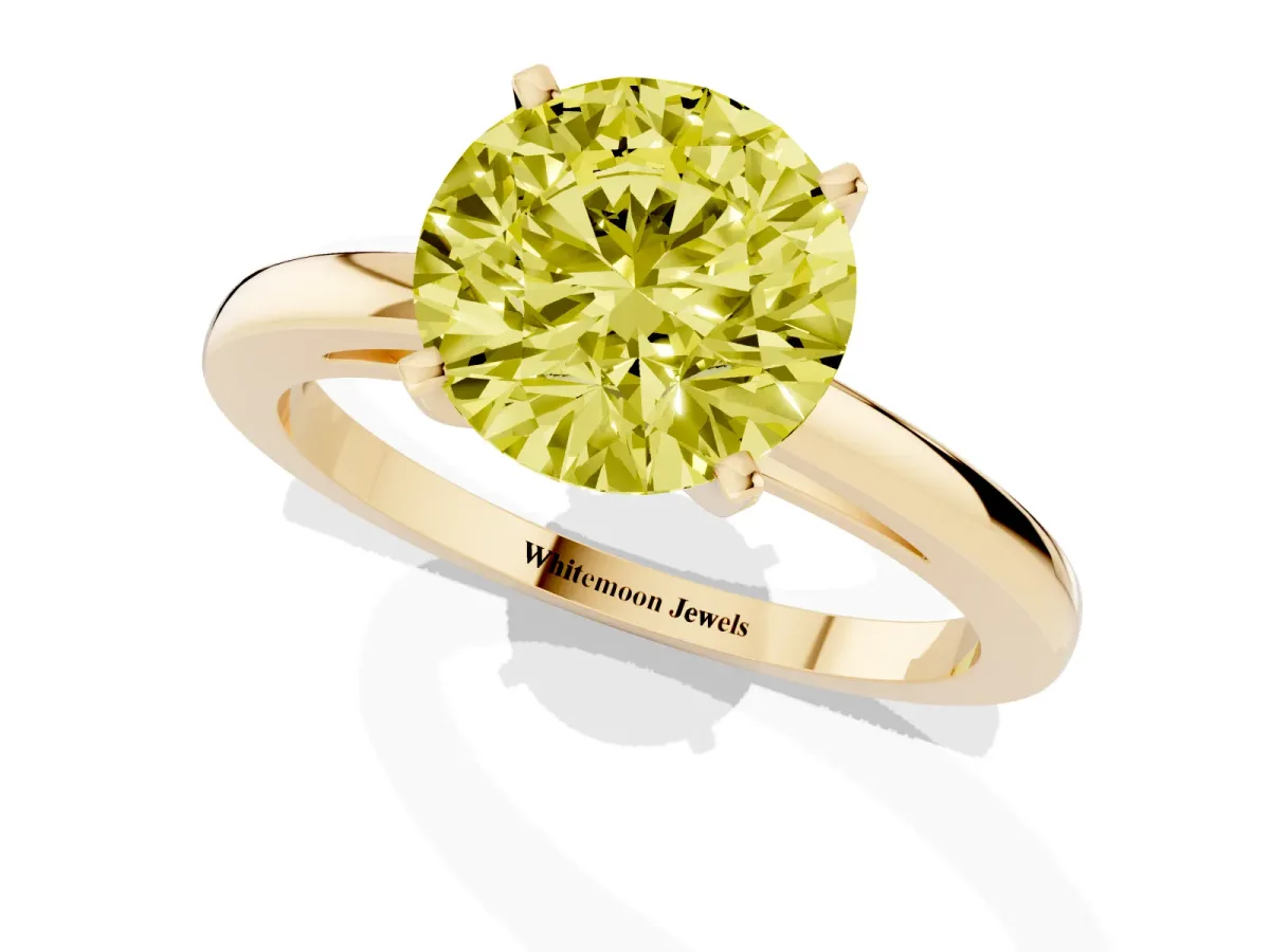 Fancy Yellow Round Cut Solitaire Diamond Engagement Ring with Four-Prong Setting on a Classic Band Yellow gold
