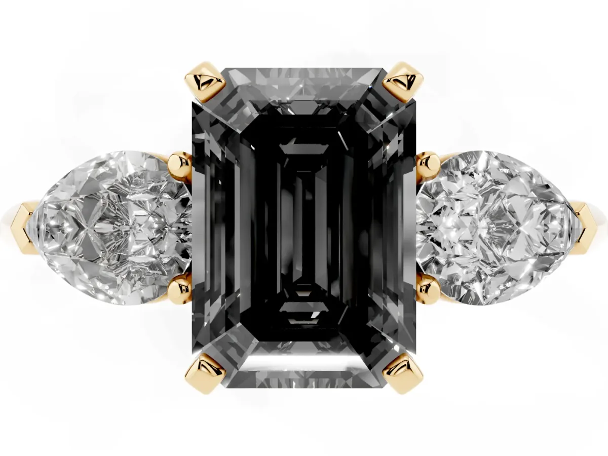 Fancy Black Three-Stone Emerald Cut Diamond Ring with Pear Side Stones and Four-Prong Setting Yellow gold