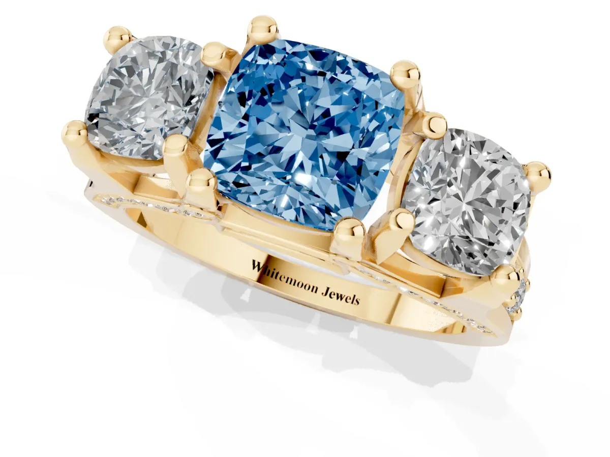 Fancy Blue Cushion Cut Diamond Three-Stone Ring with Channel Set Band and Four-Prong Setting Yellow gold