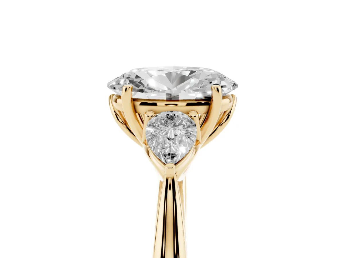Oval Cut Diamond Three-Stone Ring with Pear Side Stones and Prong Setting Yellow gold