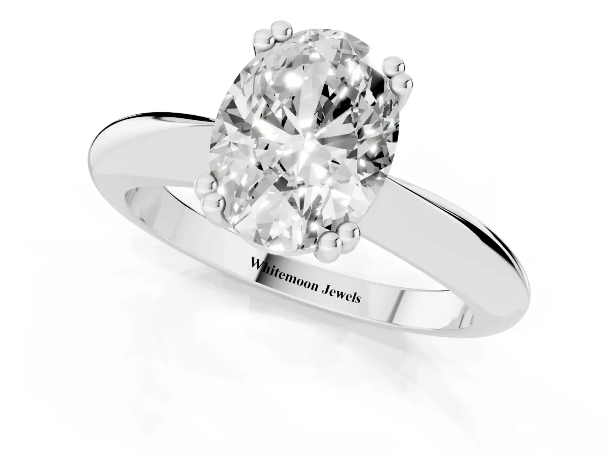 Oval Cut Cut Solitaire Engagement Ring with Tapered Band and Four-Prong Setting Silver
