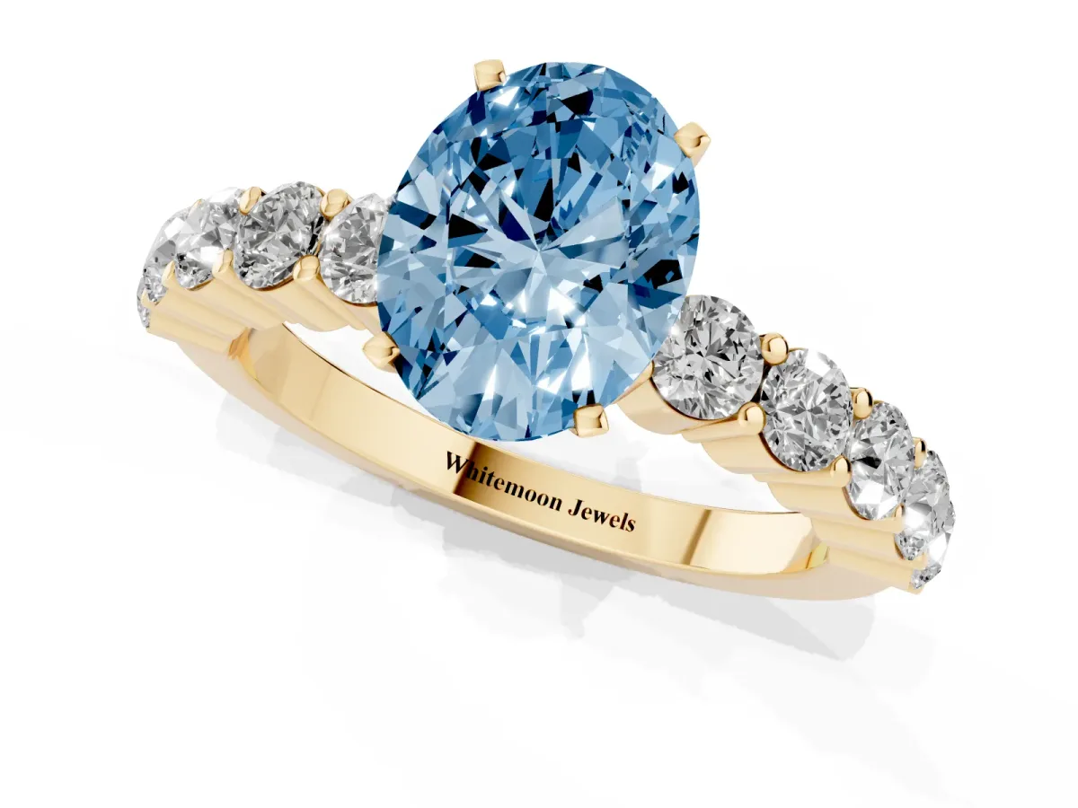 Fancy Blue Oval Cut Diamond Solitaire Ring with Shared Prong Round Side Stones Yellow gold