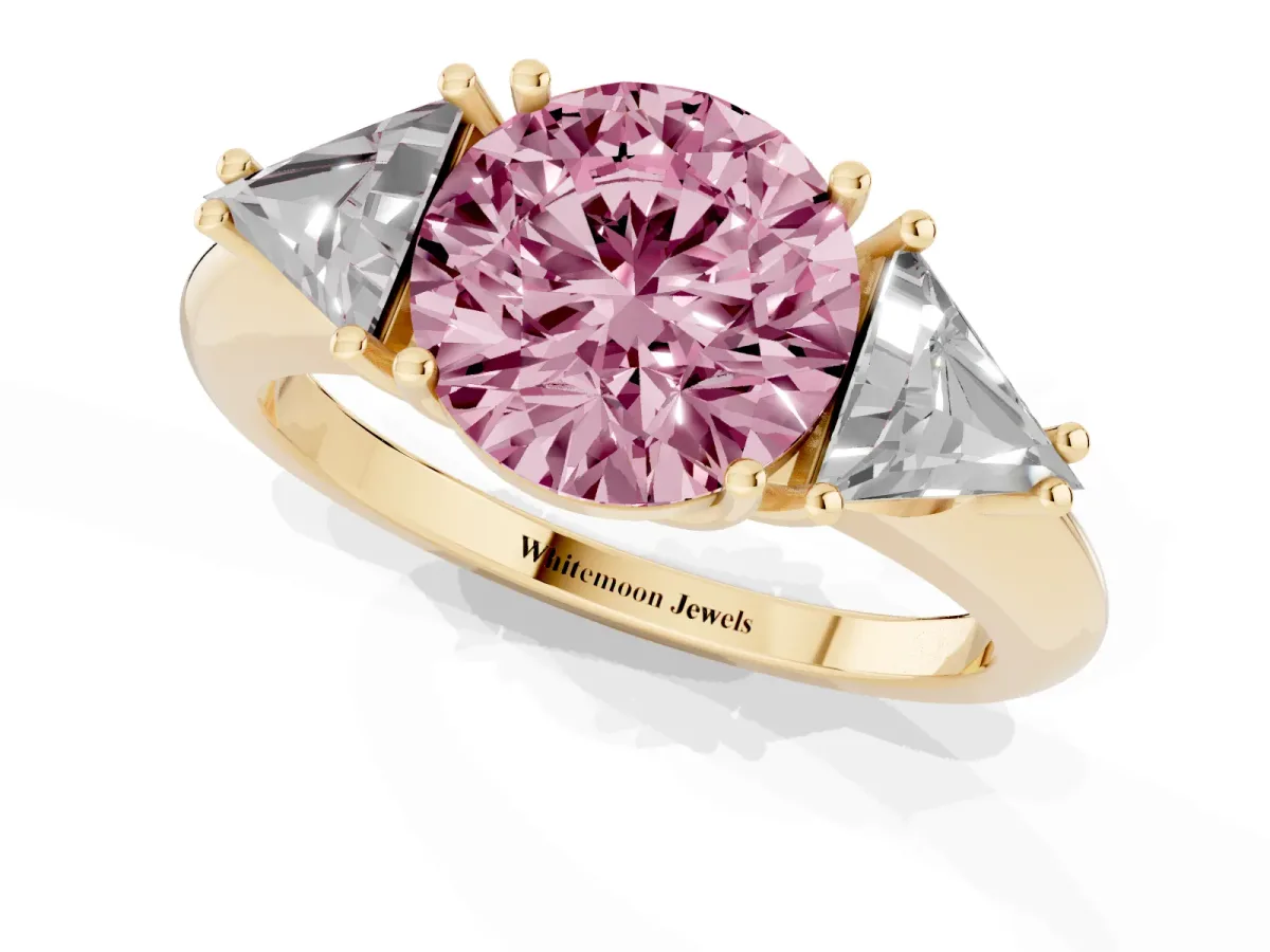Fancy Pink Three-Stone Round Cut Diamond Engagement Ring with Trillion Side Stones and Prong Setting Yellow gold