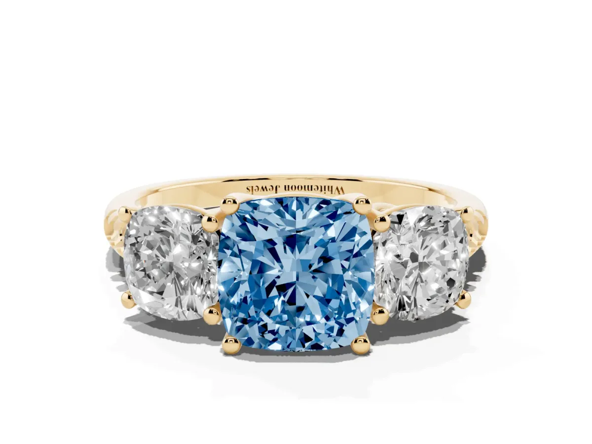 Fancy Blue Three-Stone Cushion Cut Diamond Ring with Round Pavé Band and Prong Setting Yellow gold