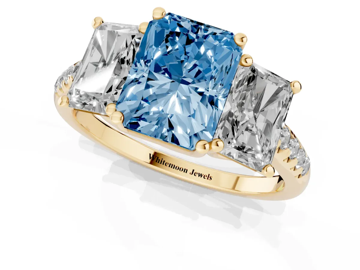Fancy Blue Three-Stone Radiant Cut Diamond Ring with Round Pavé Band and Prong Setting Yellow gold