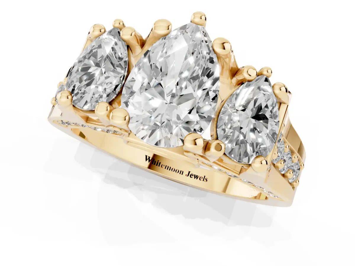 Pear Cut Diamond Three-Stone Ring with Channel Set Band and Four-Prong Setting Yellow gold