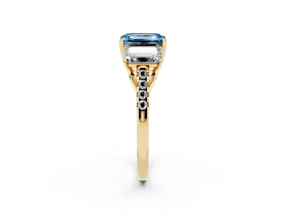 Fancy Blue Three-Stone Emerald Cut Diamond Ring with Round Pavé Band and Prong Setting Yellow gold