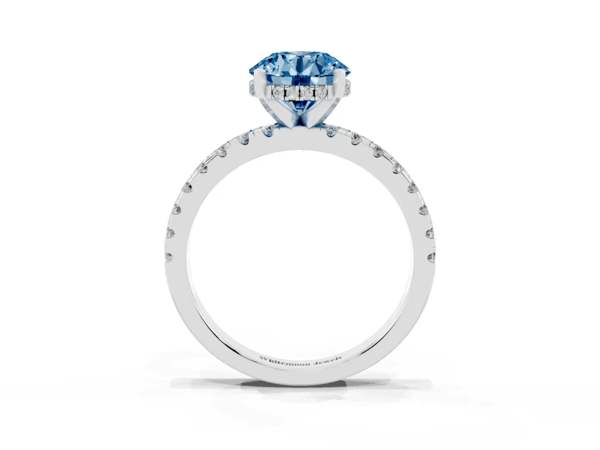 Fancy Blue Round Cut Diamond Solitaire Ring with Round Pavé Band and Four-Prong Setting Silver