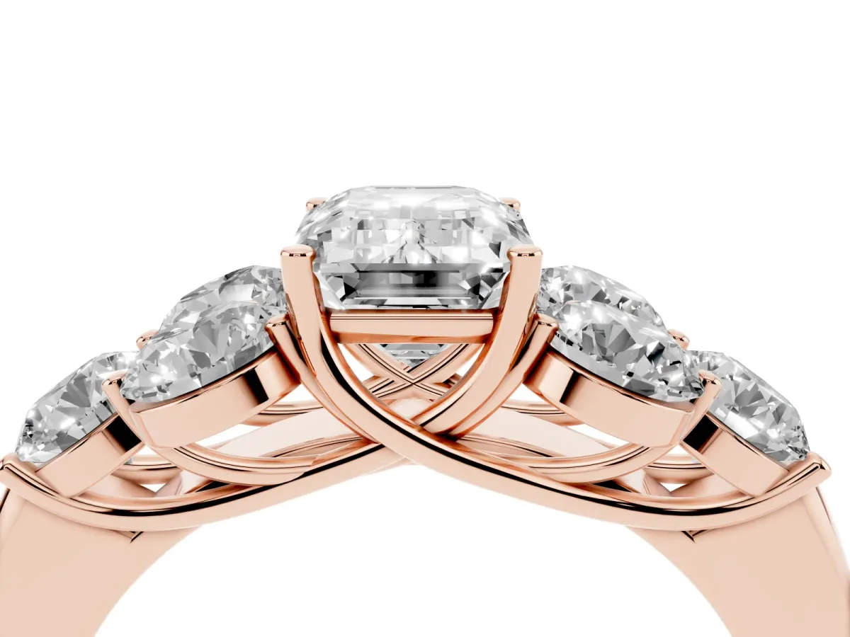 Emerald Cut Cut Diamond Cluster Ring with Round Accent Stones and Prong Setting on a Classic Band Rose gold