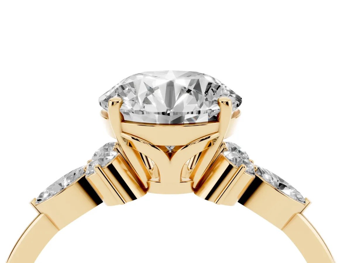 Round Cut Brilliant Diamond Solitaire Ring with Pear Side Stones and Four-Prong Setting Yellow gold