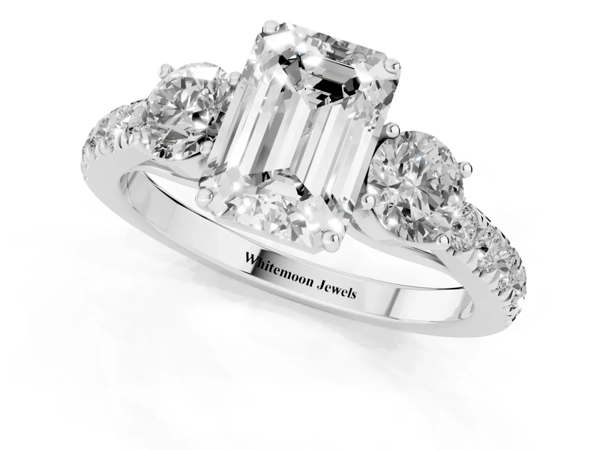 Emerald Cut Cut Diamond Three-Stone Ring with Round Side Stones and Pavé Band Platinum