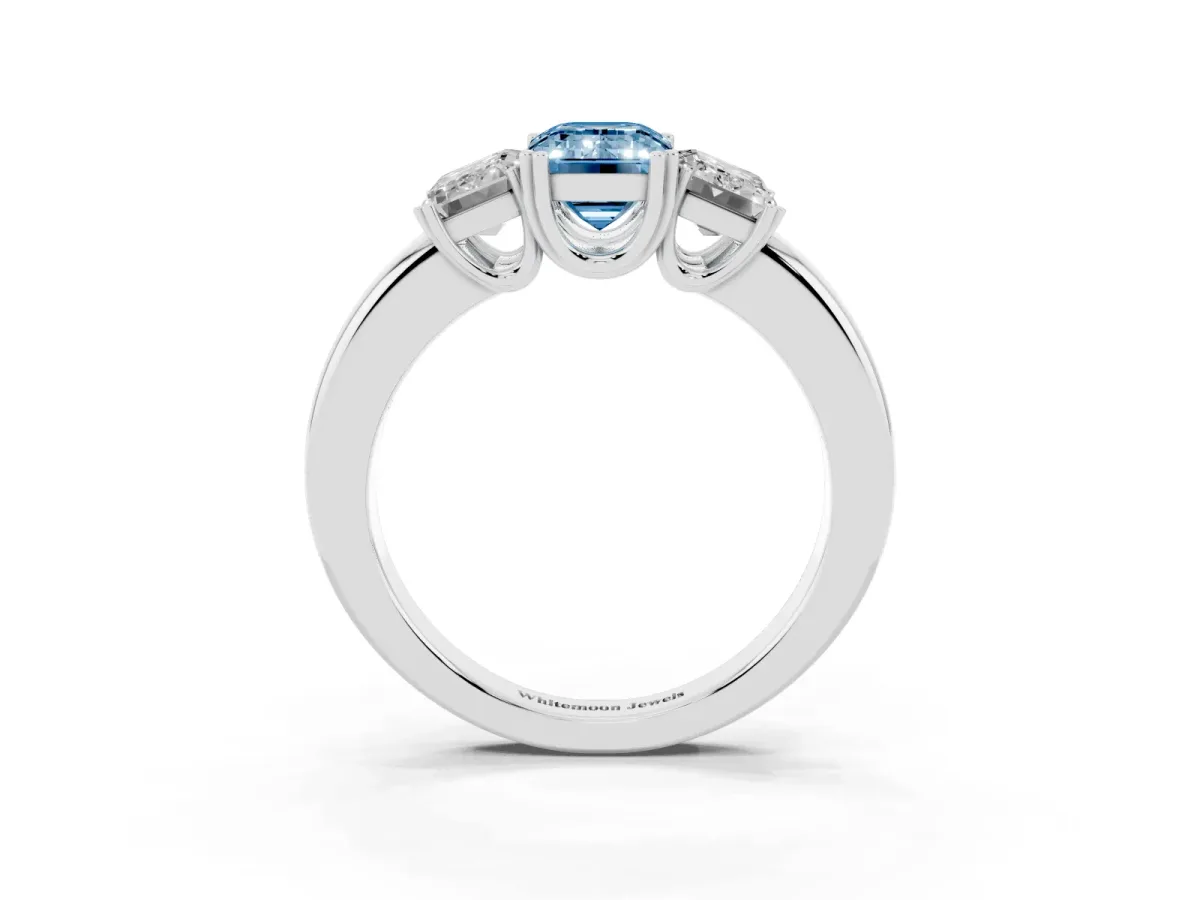 Fancy Blue Three-Stone Emerald Cut Cut Diamond Ring with Channel Set Band and Four-Prong Setting Silver