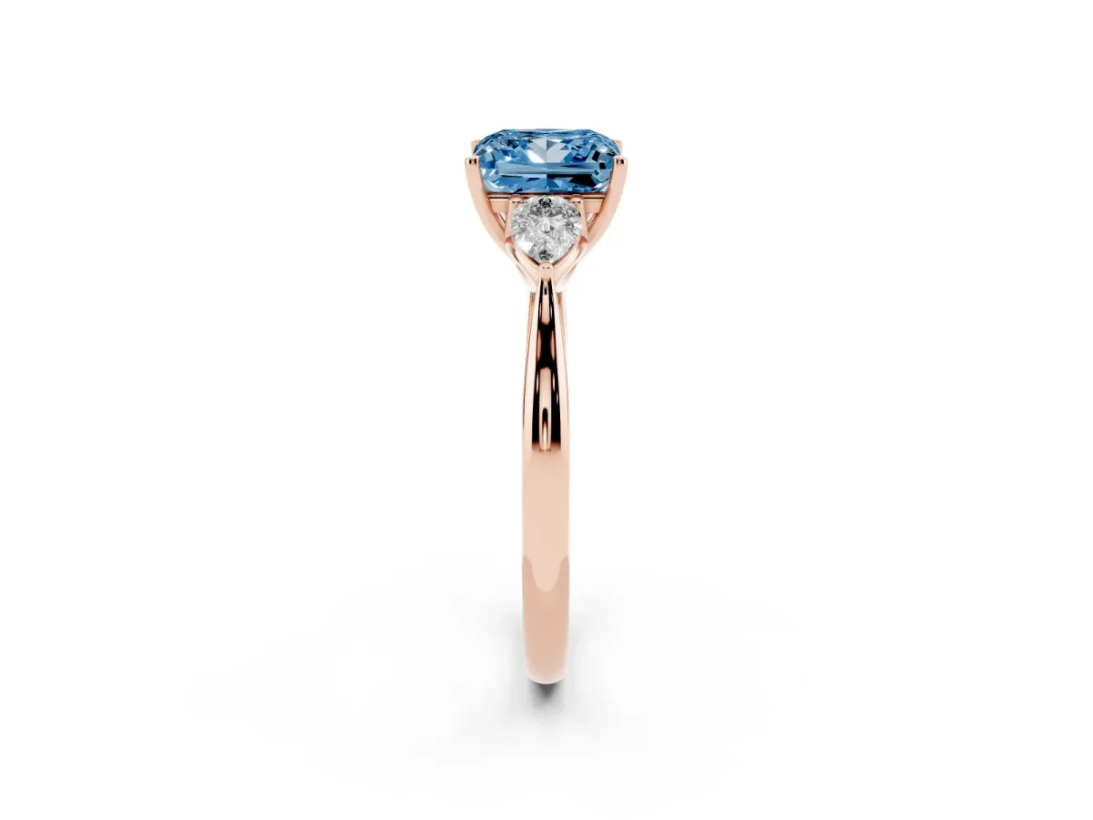 Fancy Blue Three-Stone Princess Cut Diamond Ring with Pear Side Stones in Four-Prong Setting Rose gold