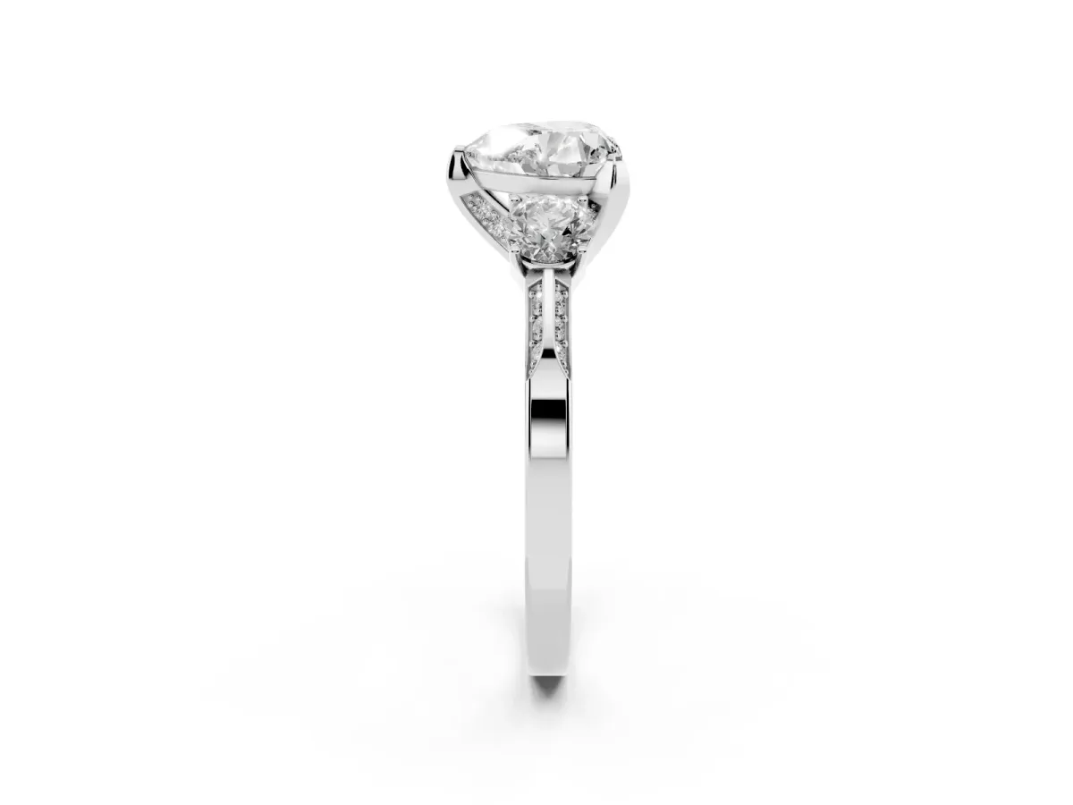 Heart Cut Brilliant Three-Stone Diamond Ring with Pavé Band and Four-Prong Setting Platinum