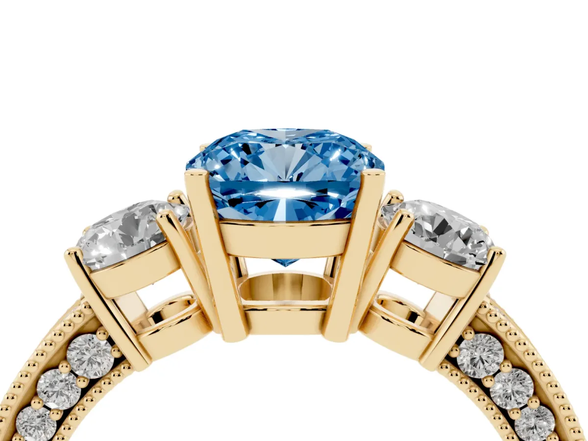 Fancy Blue Cushion Cut Three-Stone Diamond Ring with Pavé Band and Four-Prong Setting Yellow gold
