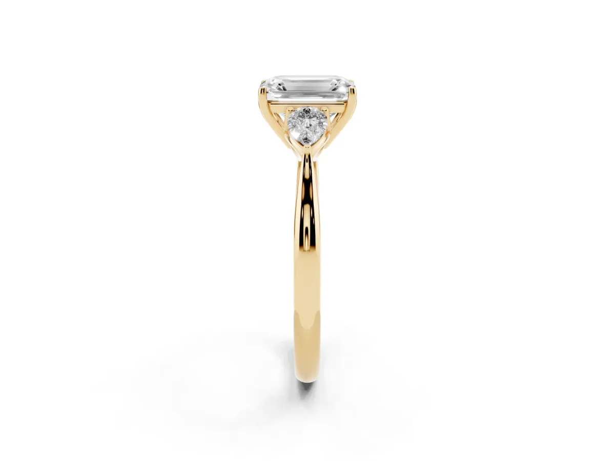 Emerald Cut Diamond Three-Stone Ring with Pear Side Stones and Prong Setting Yellow gold