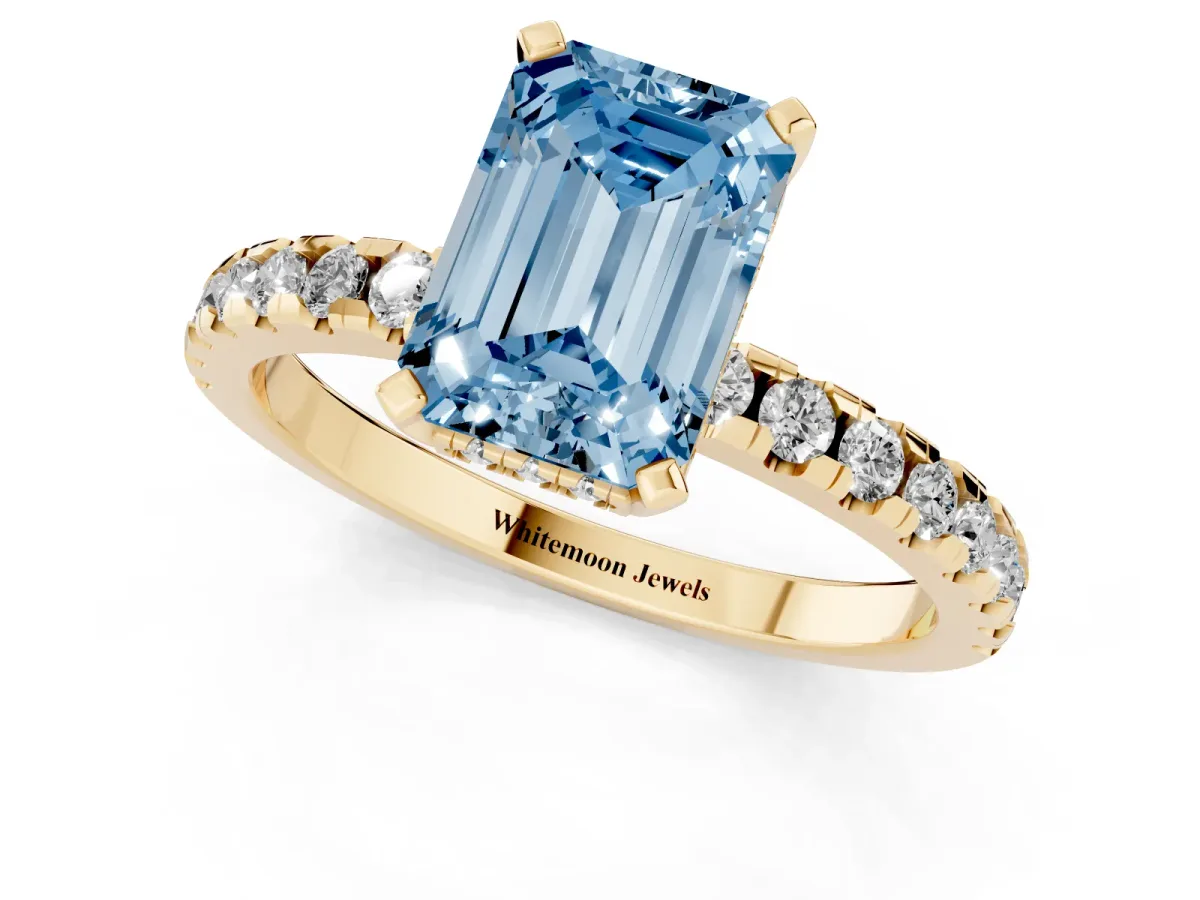 Fancy Blue Emerald Cut Diamond Solitaire Ring with Round Pavé Band and Four-Prong Setting Yellow gold