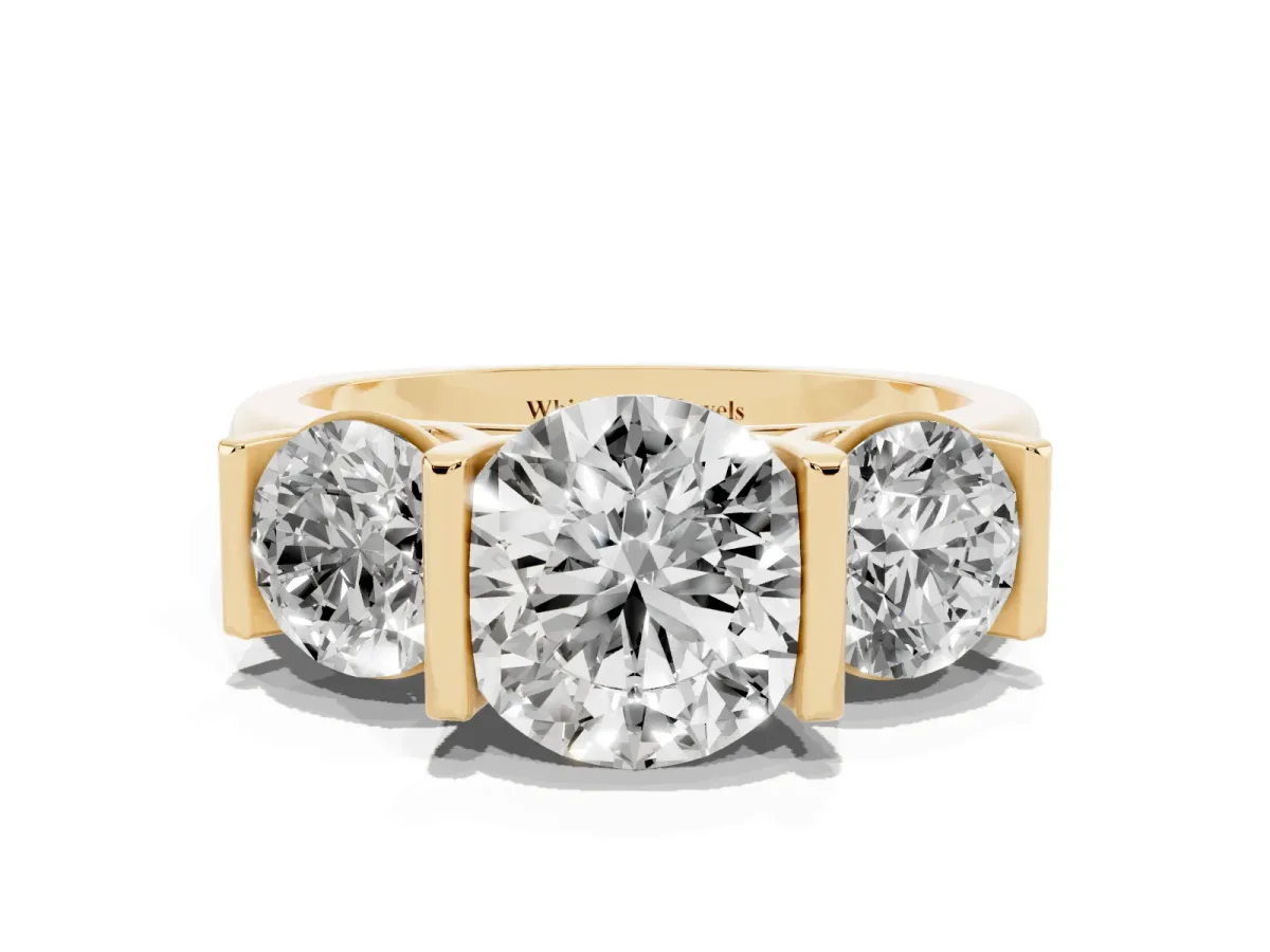 Three-Stone Round Cut Brilliant Diamond Ring with Channel Setting and White Gold Band Yellow gold