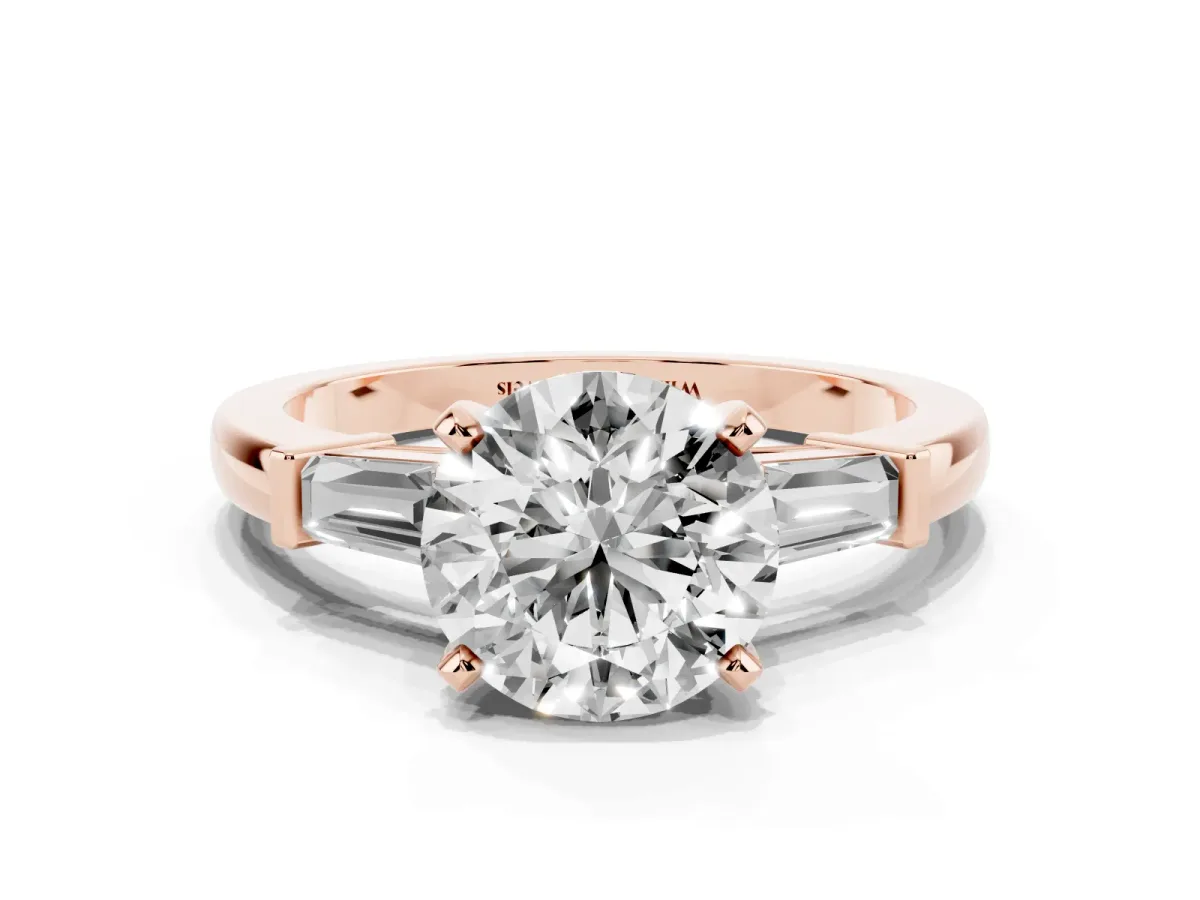Round Cut Cut Diamond Solitaire Ring with Tapered Baguette Accents and Four-Prong Setting Rose gold