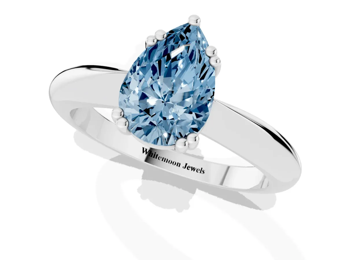 Fancy Blue Pear Cut Cut Solitaire Engagement Ring with Tapered Band and Four-Prong Setting White gold