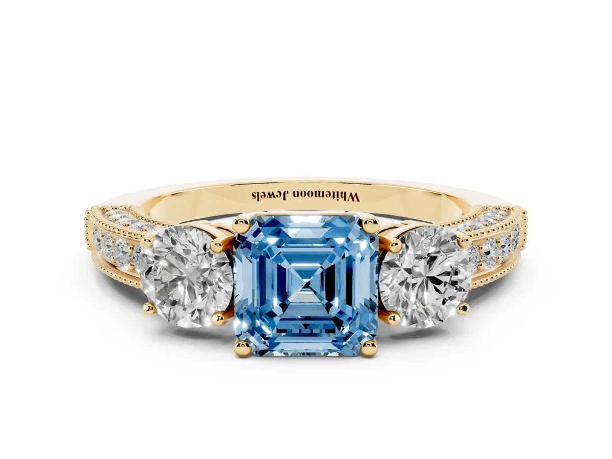 Fancy Blue Asscher Cut Three-Stone Diamond Ring with Pavé Band and Four-Prong Setting Yellow gold