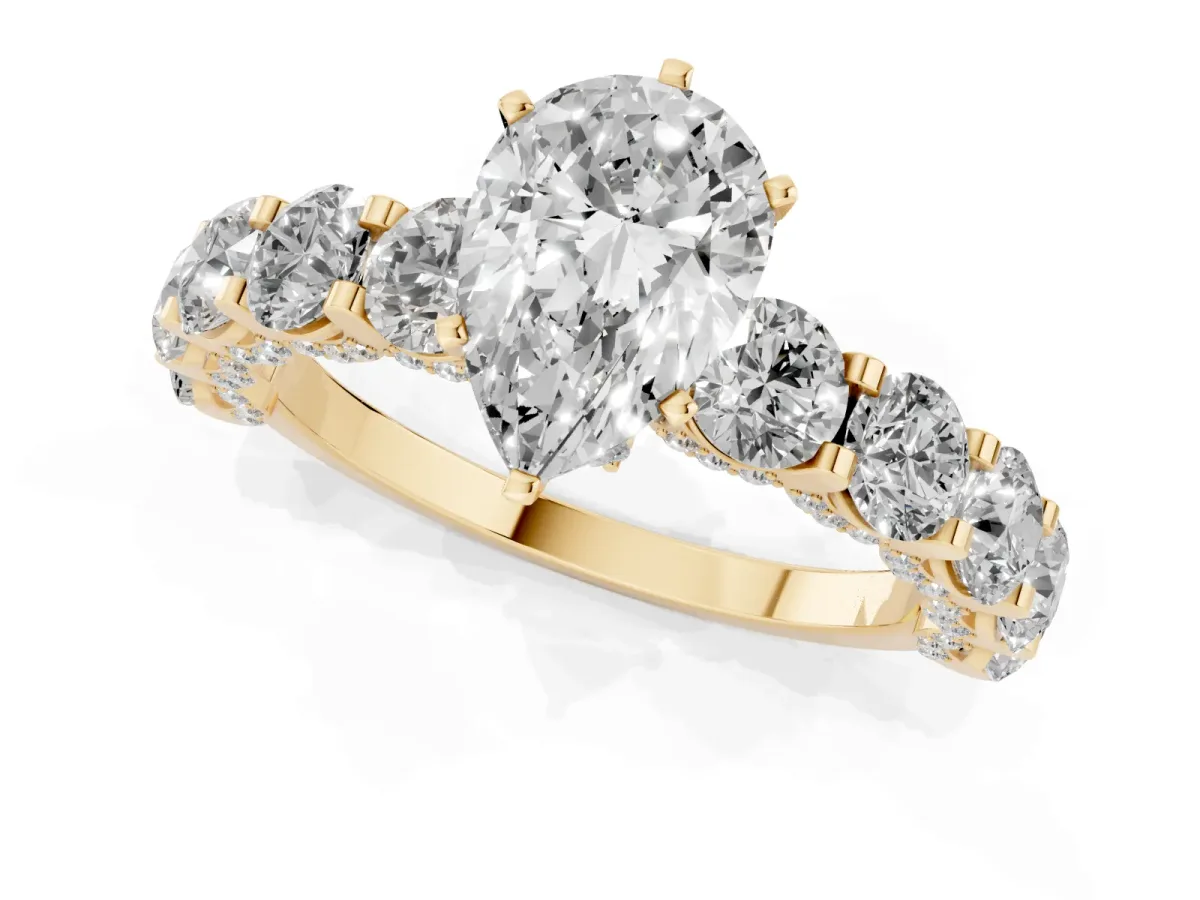 Pear Cut Diamond Side Stone Engagement Ring with Four-Prong Setting Yellow gold