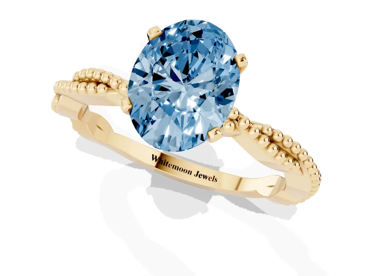 Fancy Blue Oval Cut Solitaire Twisted Band with Bead Prong Setting Yellow gold