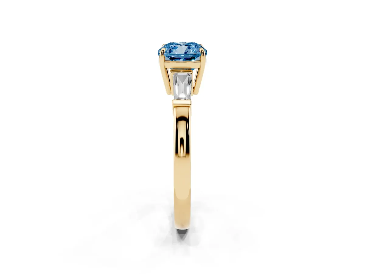Fancy Blue Cushion Cut Diamond Three-Stone Ring with Tapered Baguette Side Stones and Prong Setting Yellow gold