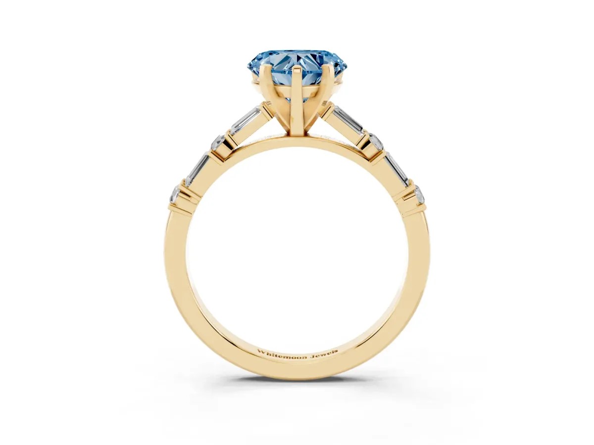 Fancy Blue Heart Cut Diamond Solitaire with Side Baguettes and Channel Set Band Yellow gold