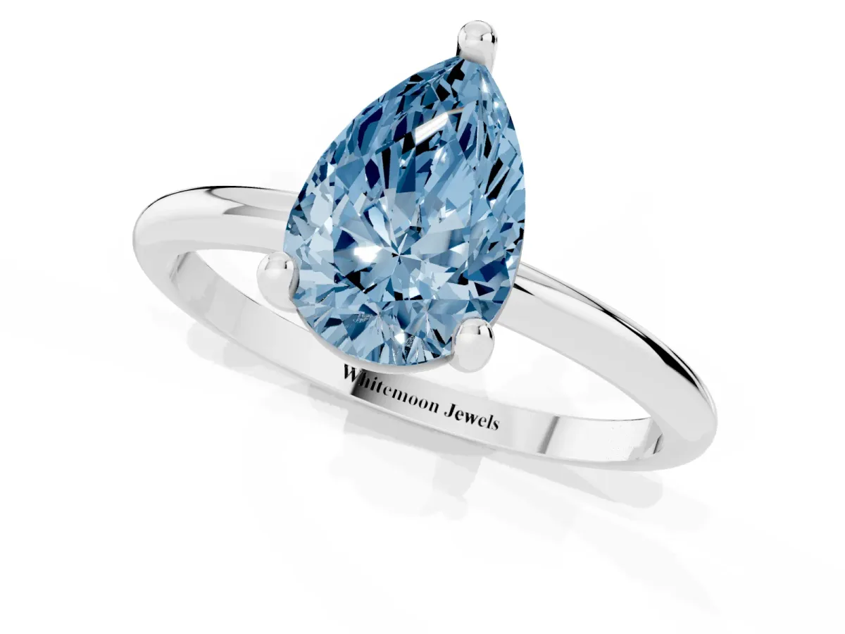 Fancy Blue Pear Cut Solitaire Diamond Ring with 4-Prong Setting on a Classic Band Silver