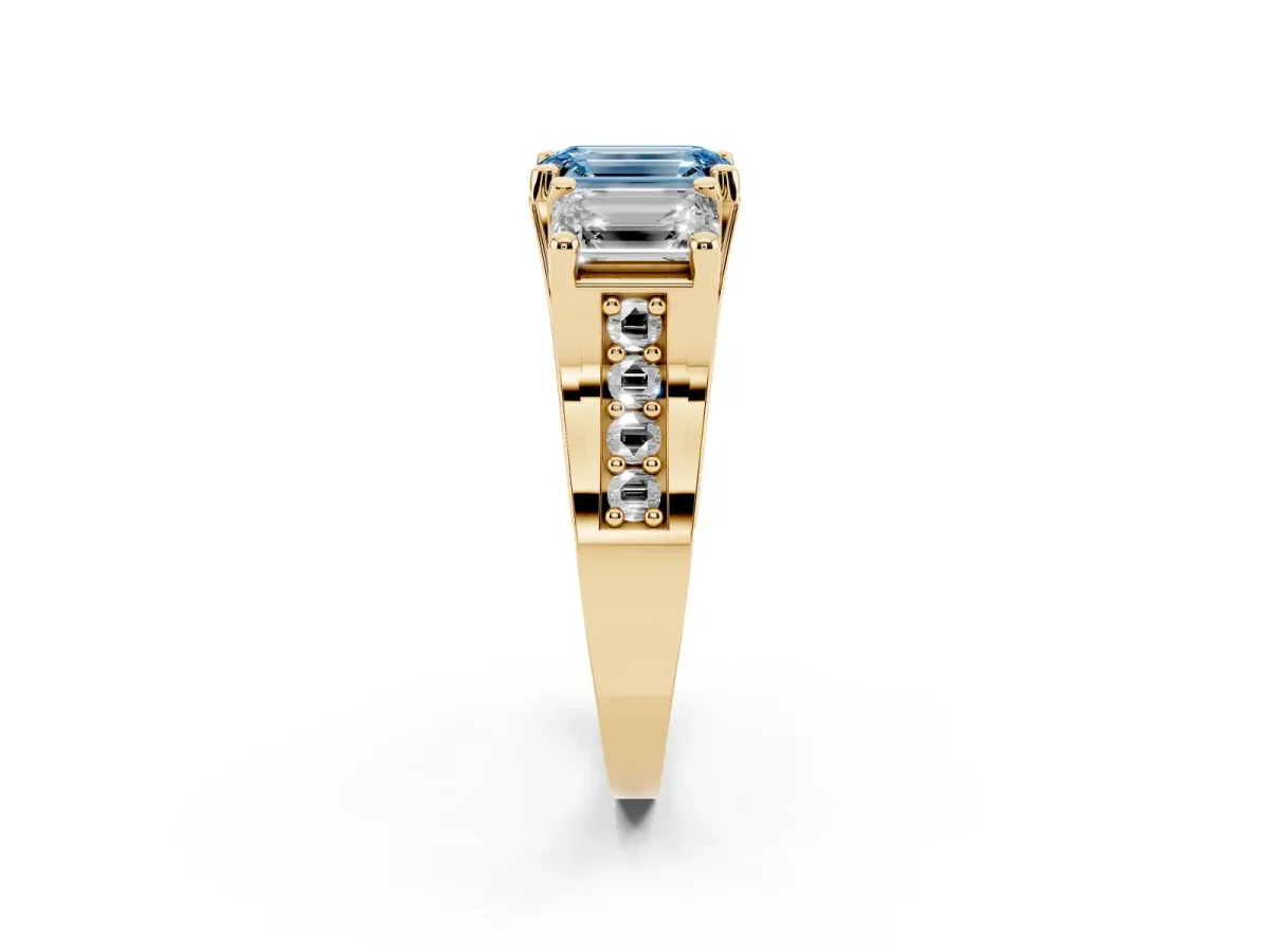 Fancy Blue Emerald Cut Diamond Three-Stone Ring with Channel Set Band and Four-Prong Setting Yellow gold