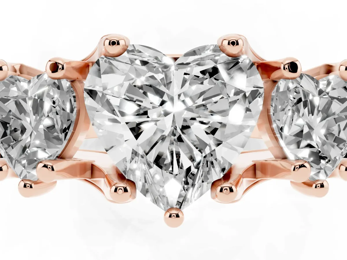 Heart Cut Diamond Three-Stone Ring with Channel Set Band and Four-Prong Setting Rose gold