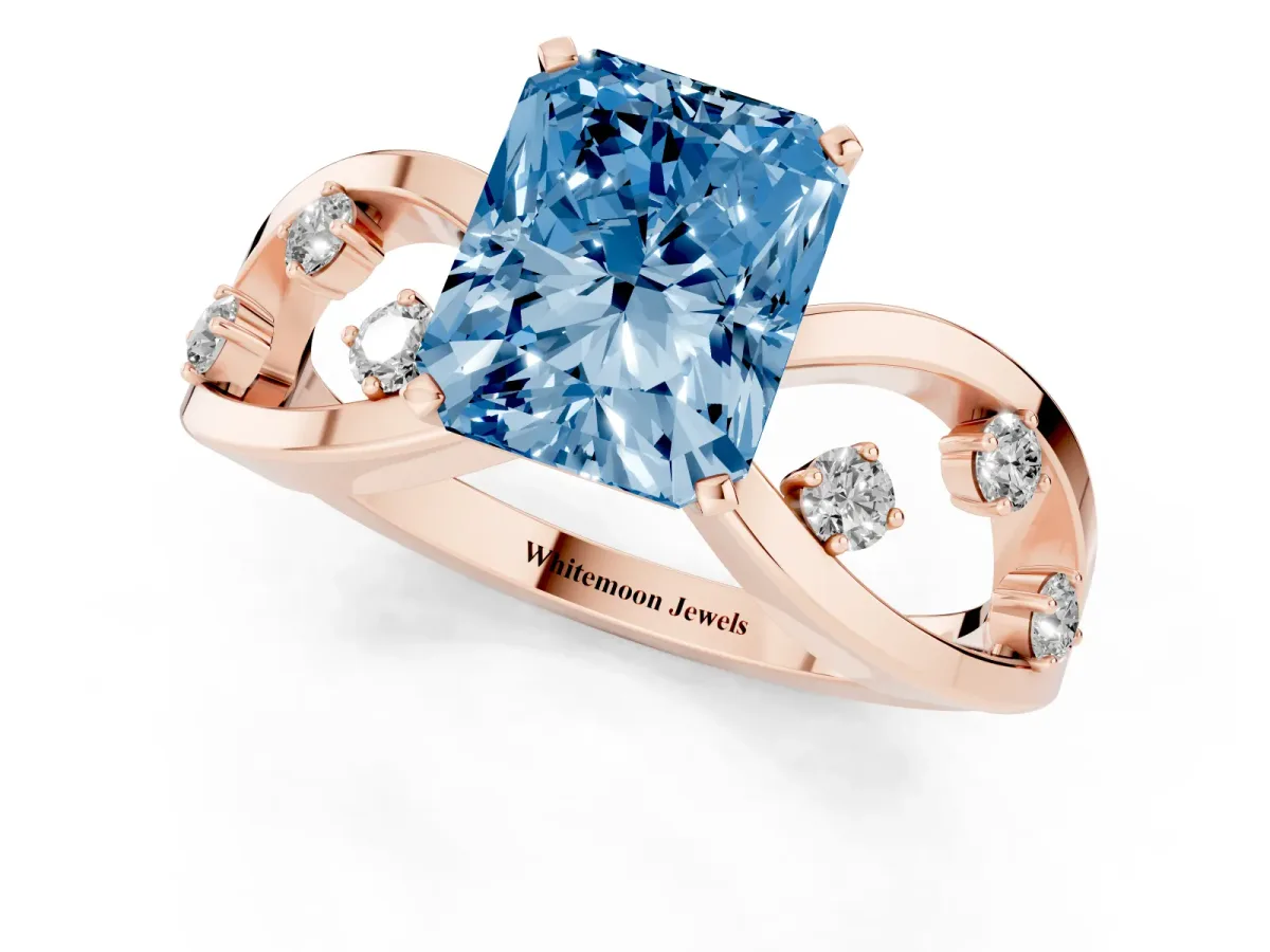 Fancy Blue Radiant Cut Cut Solitaire Diamond with Side Stones on Criss-Cross Band and Four-Prong Setting Rose gold