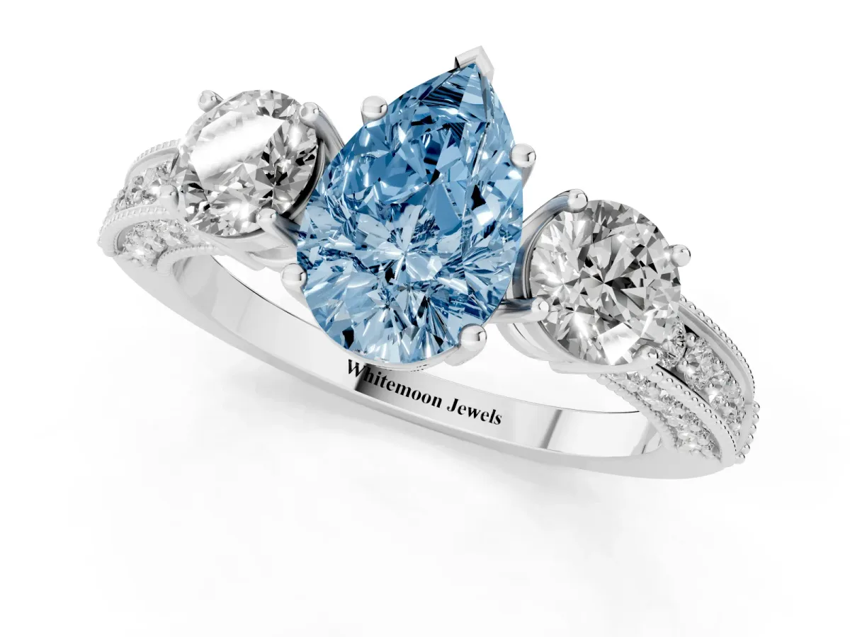 Fancy Blue Pear Cut Three-Stone Diamond Ring with Pavé Band and Four-Prong Setting Silver