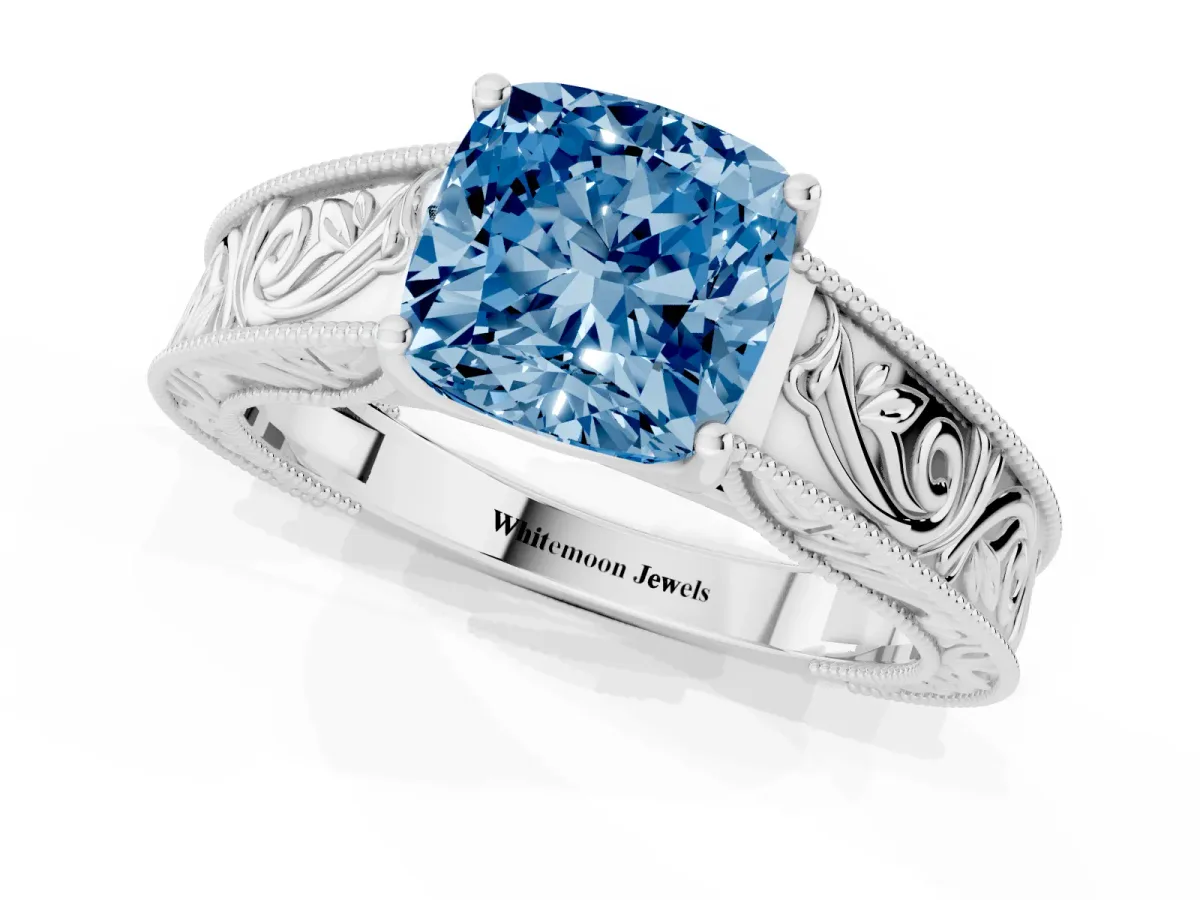 Fancy Blue Cushion Cut Diamond Solitaire Ring with Engraved Band and Four-Prong Setting Platinum