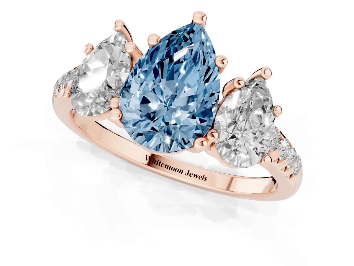 Fancy Blue Three-Stone Pear Cut Diamond Ring with Round Pavé Band and Prong Setting Rose gold
