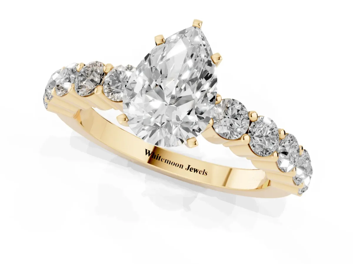 Pear Cut Diamond Solitaire Ring with Shared Prong Round Side Stones Yellow gold