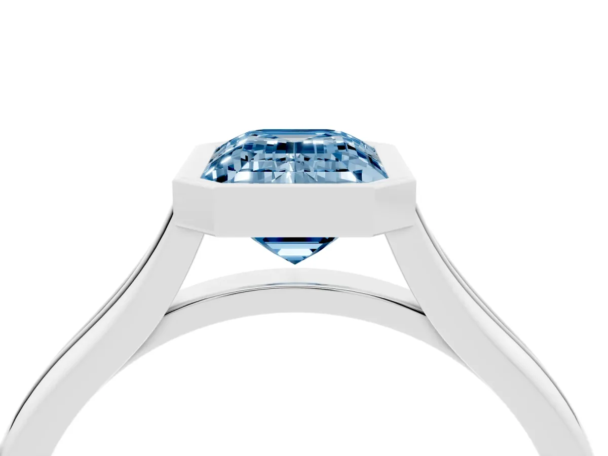 Fancy Blue Bezel Set Emerald Cut Cut Solitaire Ring with Tapered Band Silver