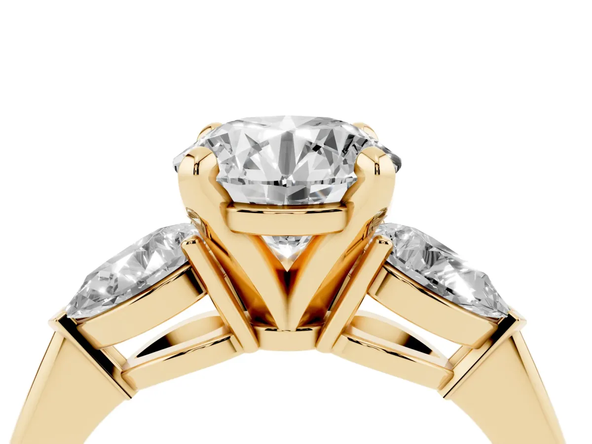 Three-Stone Round Cut Diamond Ring with Pear Side Stones and Four-Prong Setting Yellow gold