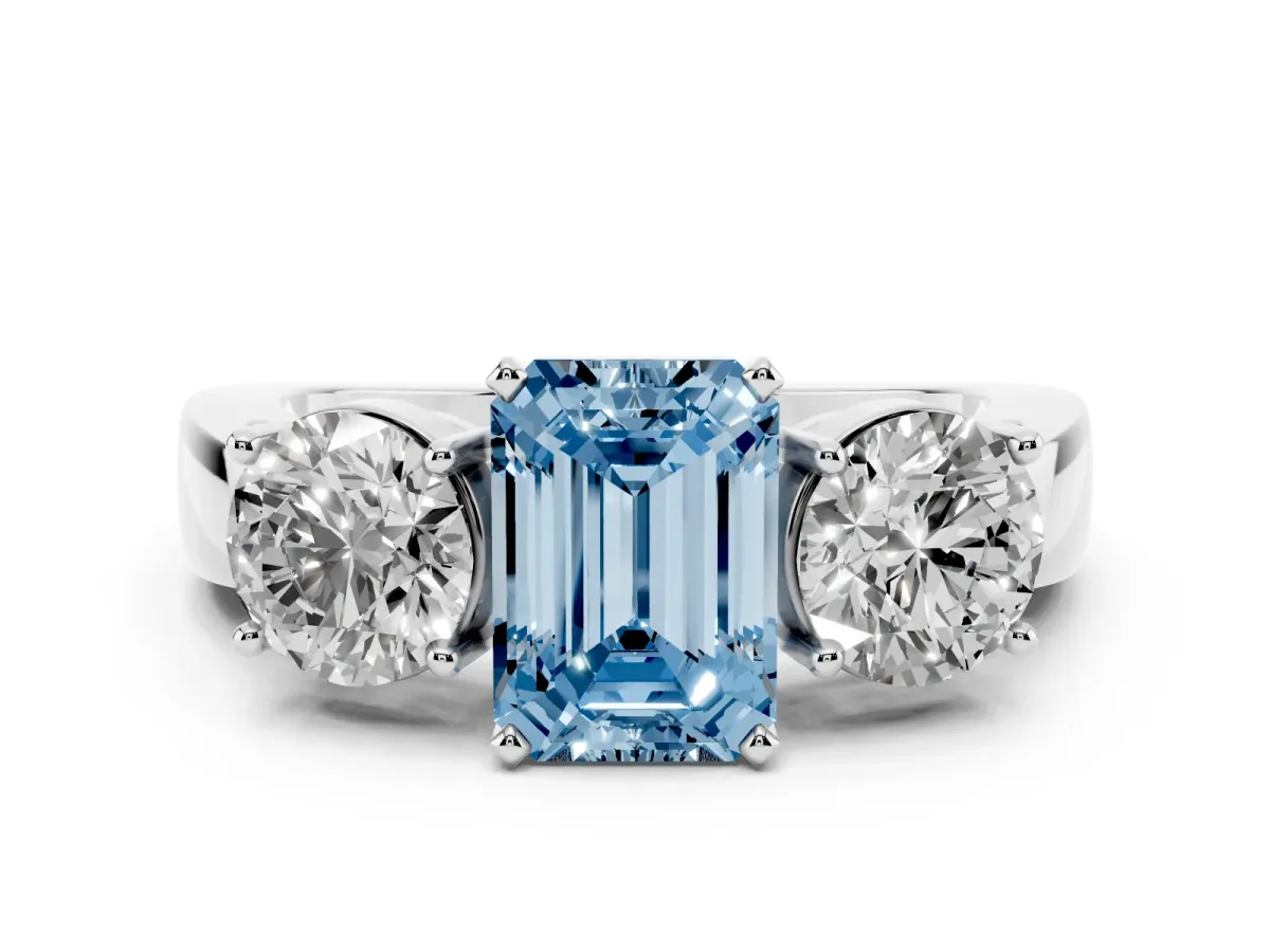 Fancy Blue Three-Stone Emerald Cut Diamond Ring with Round Side Stones, Classic Band, and Four-Prong Setting Silver